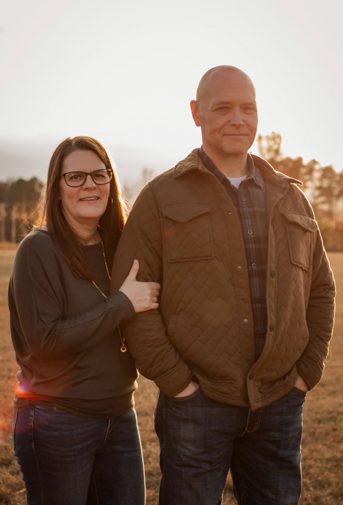 One of the families behind Ark Roofing and Gutters, a couple photographed at sunset