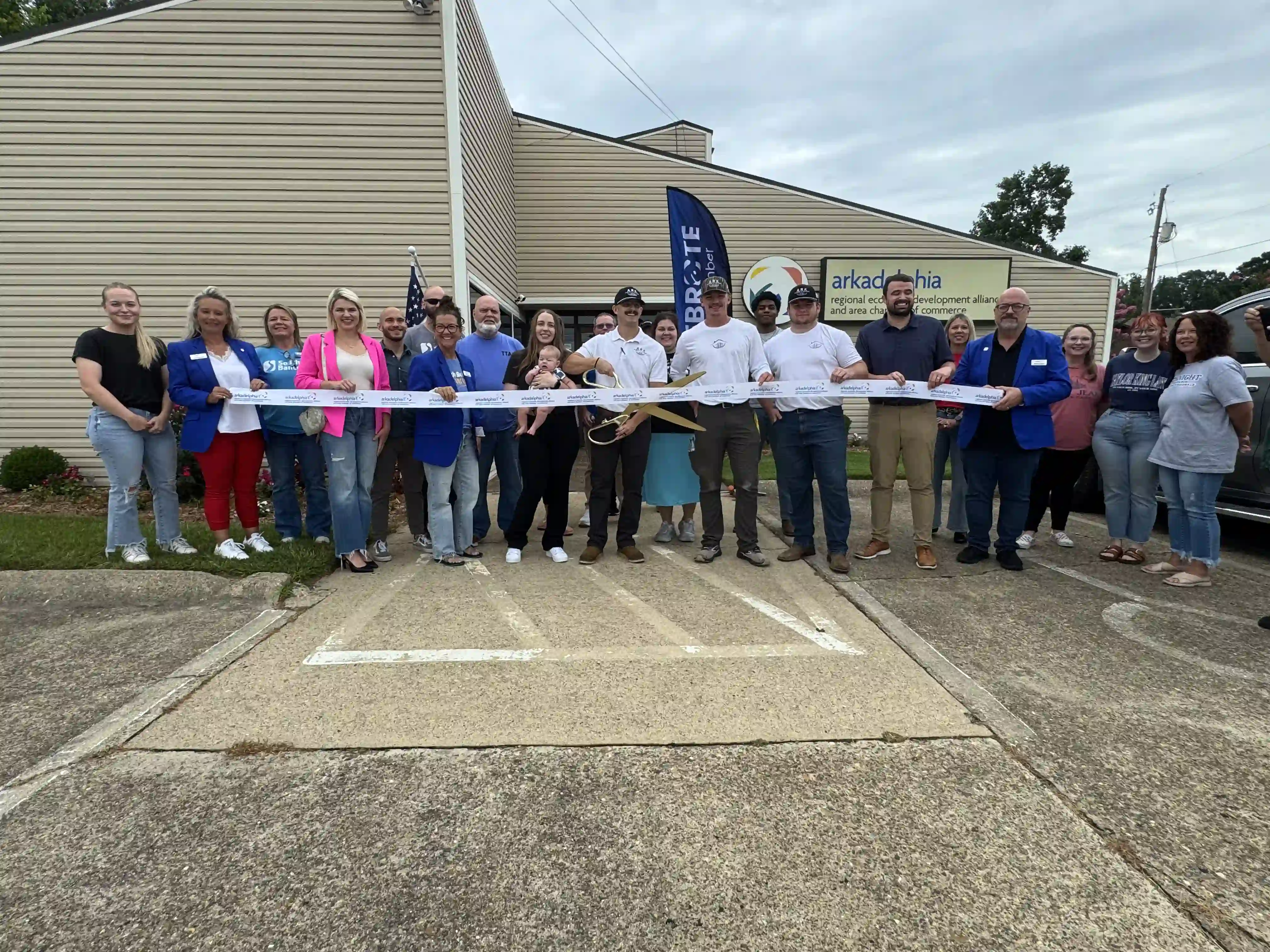 Ark Roofing and Gutters crew and family at their Arkadelphia chamber of commerce ribbon cutting