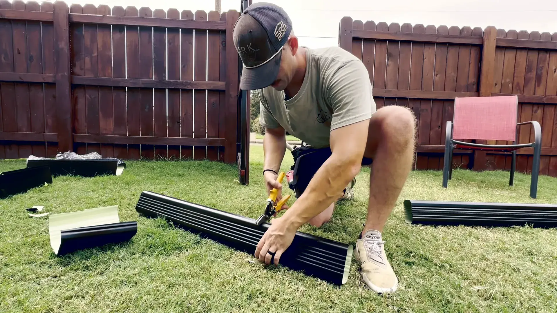 Seamless gutter being formed on site from a roll of aluminum coil outside an Arkansas home