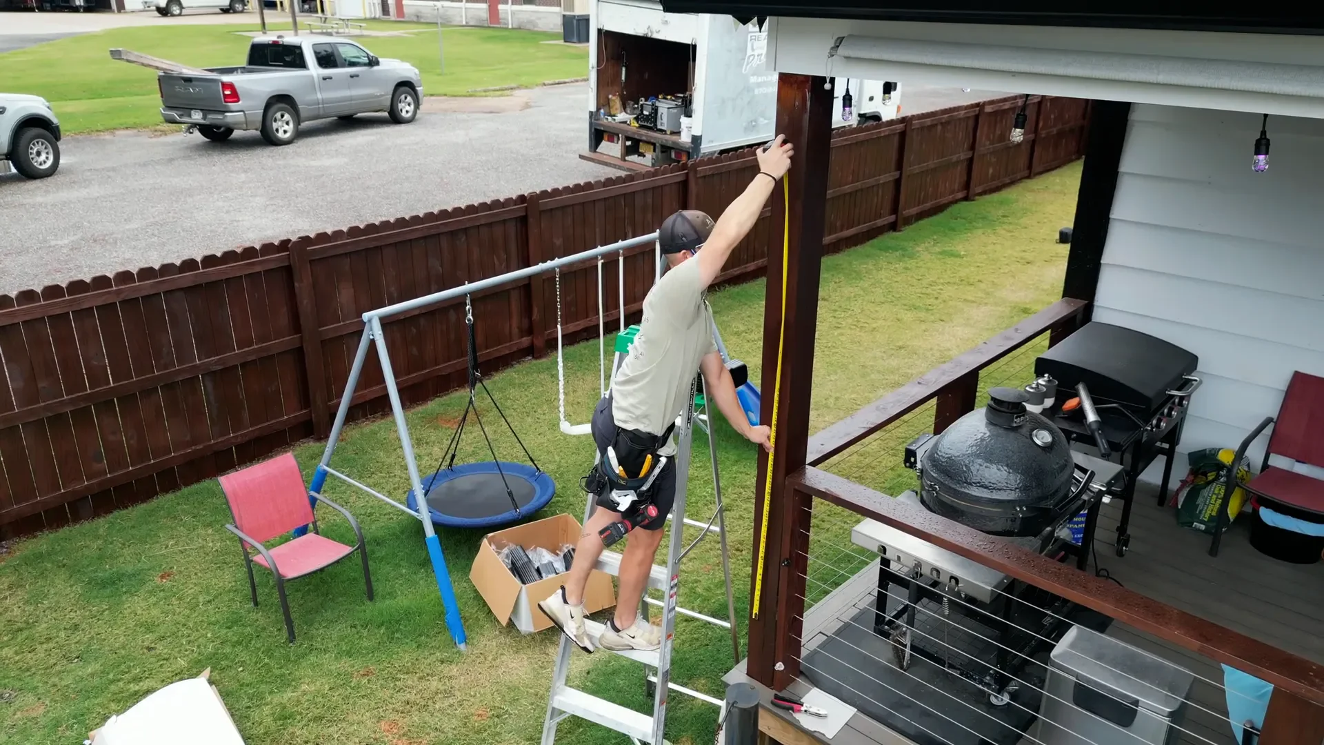 Technician measuring an eave with a tape before cutting replacement gutter lengths