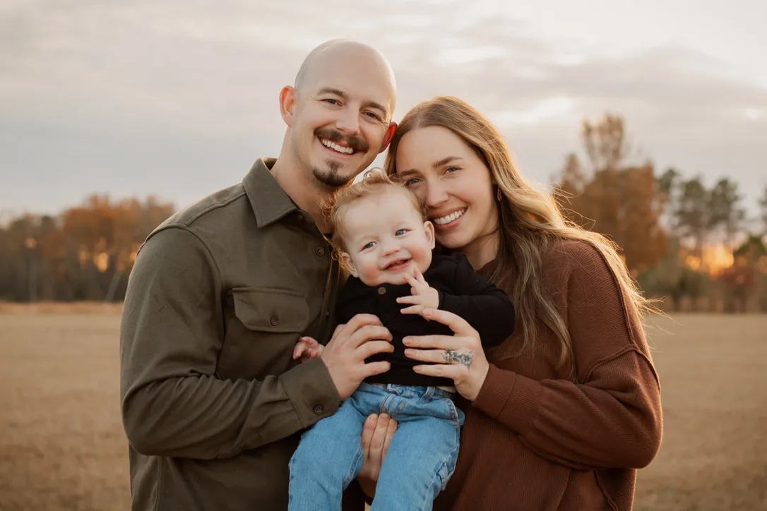 Nate, founder of Ark Roofing and Gutters, with his wife and young son