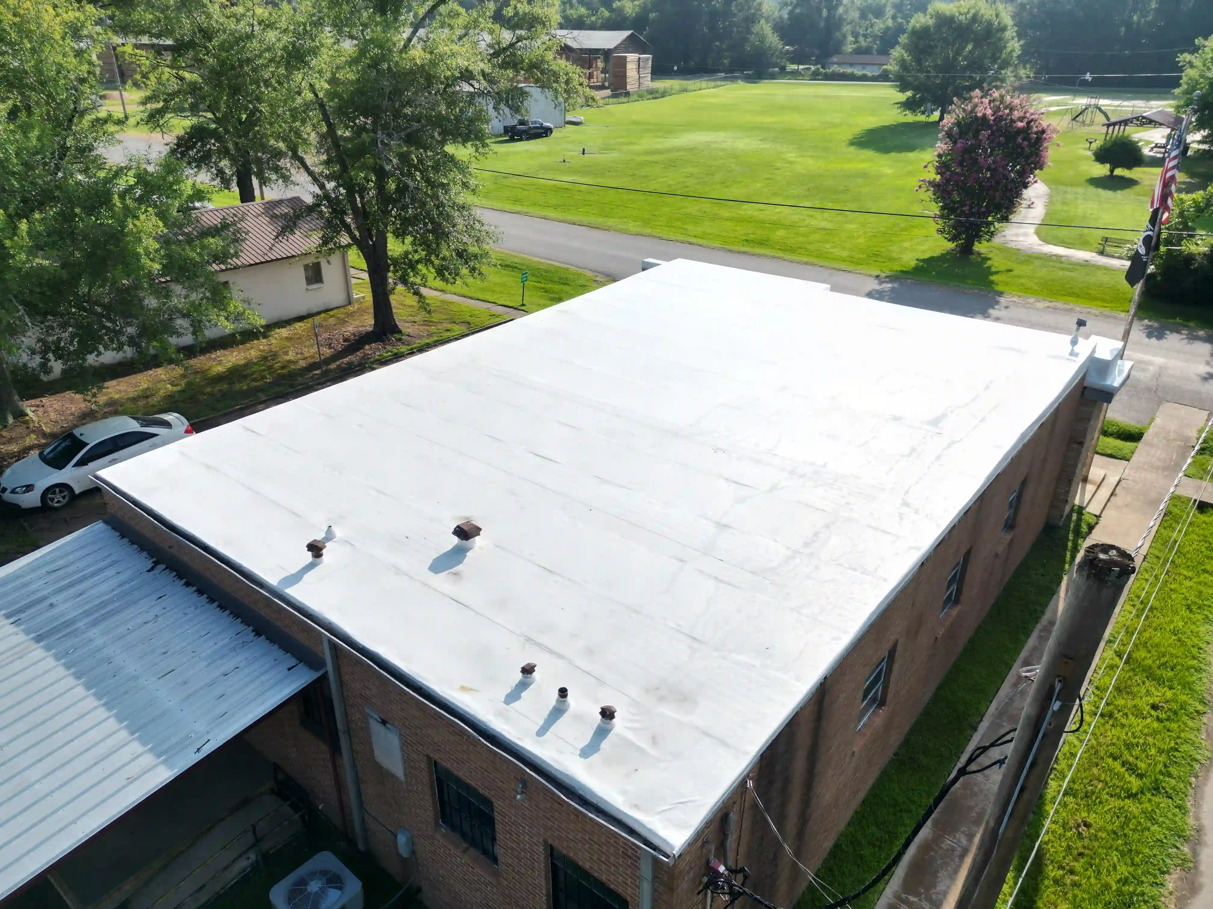 Finished white membrane roof on a low-slope commercial building with rooftop units