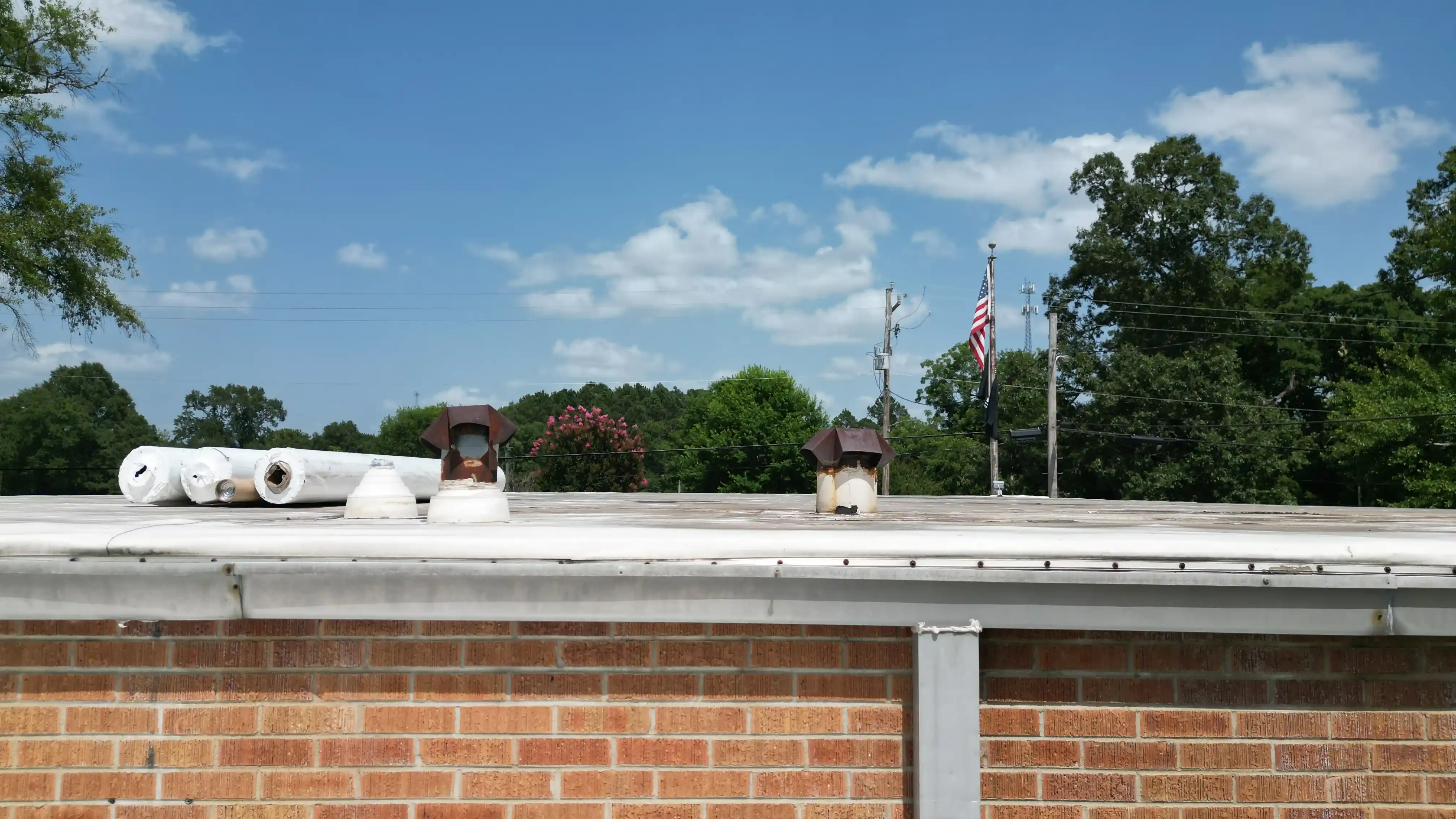 Commercial building roof before restoration, showing aging membrane