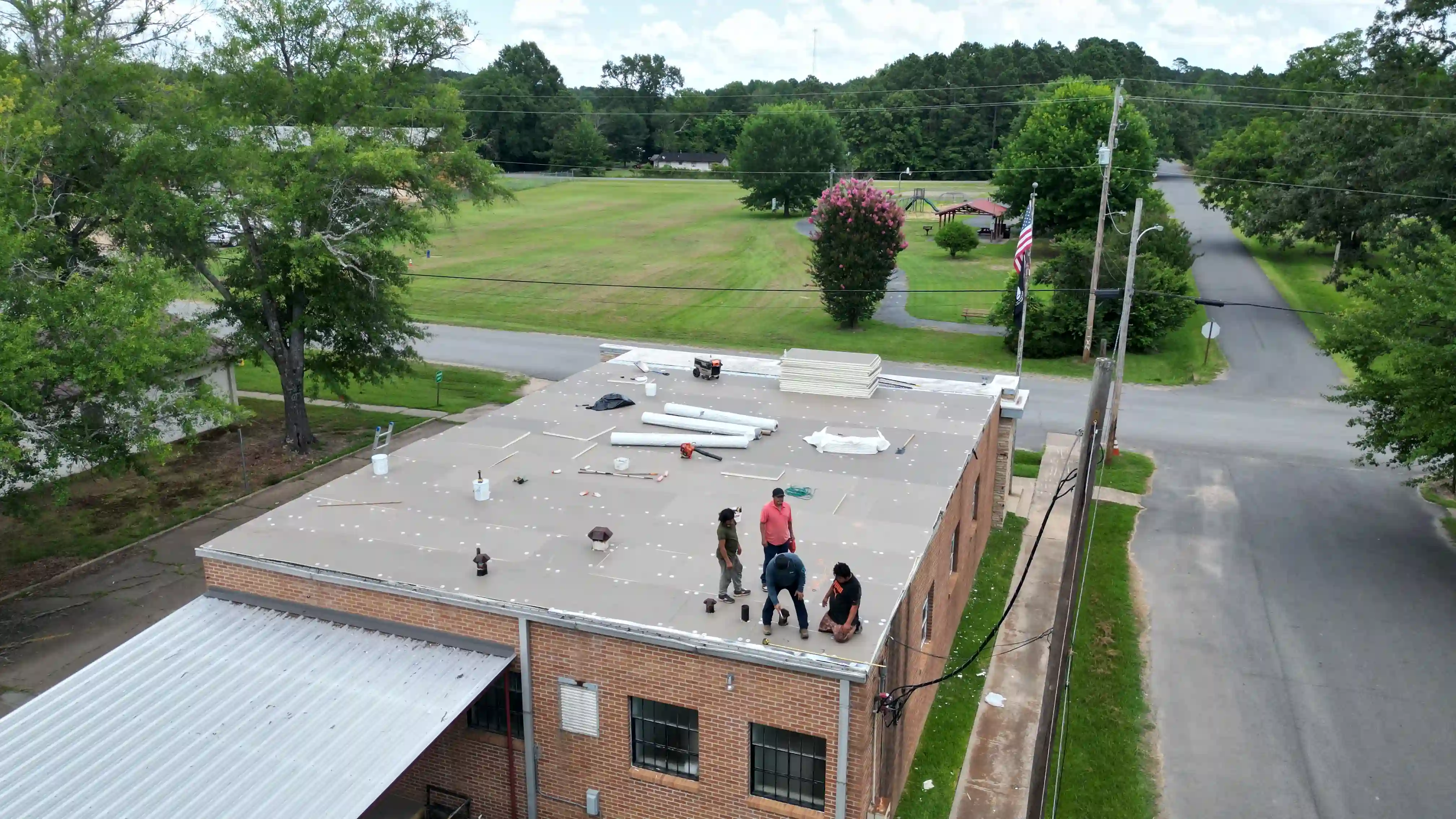 Insulation board being installed during a commercial roof replacement