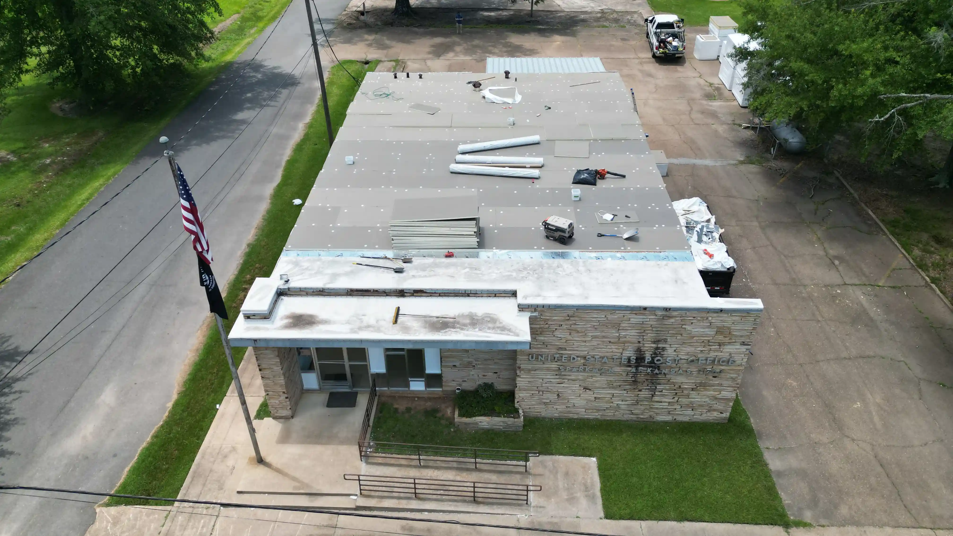 Commercial roof membrane repair in progress on a low-slope building